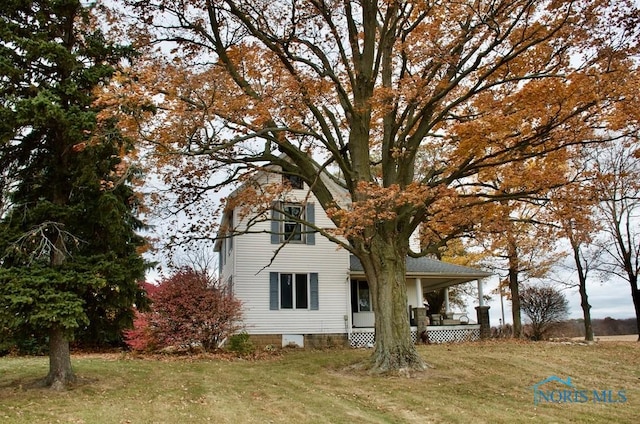 exterior space featuring a porch and a front lawn