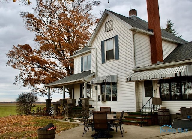 back of property with a patio