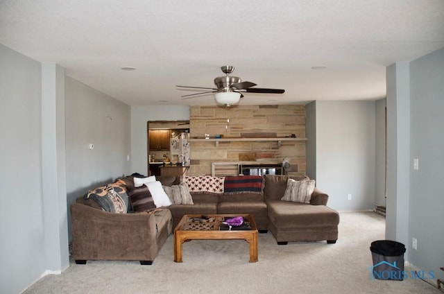 carpeted living room with ceiling fan