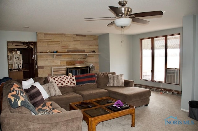 living room with a stone fireplace, cooling unit, and carpet flooring