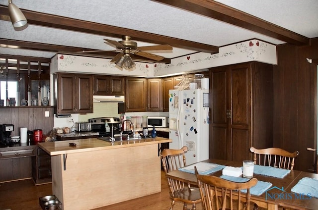 kitchen featuring white appliances, beam ceiling, ceiling fan, dark brown cabinetry, and sink