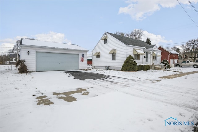 view of front facade featuring a garage and an outbuilding