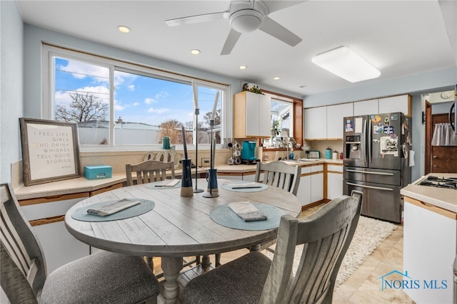 dining room featuring ceiling fan and sink