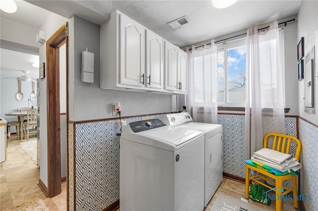 washroom featuring separate washer and dryer, electric panel, cabinets, and ceiling fan