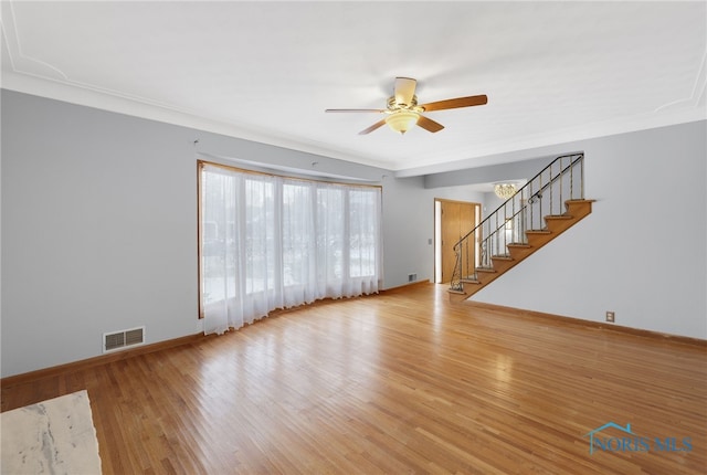 unfurnished living room featuring ceiling fan, crown molding, and light wood-type flooring