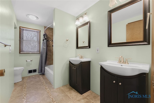 full bathroom with tile patterned flooring, shower / bath combo with shower curtain, vanity, and toilet