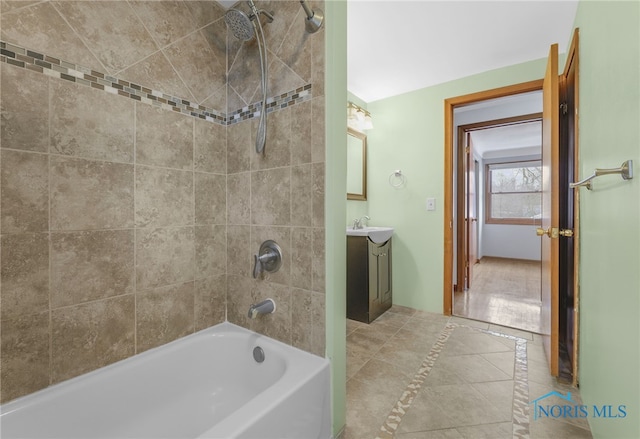 bathroom featuring tile patterned floors, vanity, and tiled shower / bath