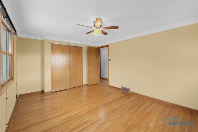 unfurnished bedroom with ceiling fan and light hardwood / wood-style floors