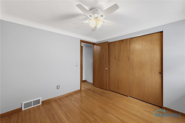 unfurnished bedroom with ceiling fan, a closet, and light wood-type flooring