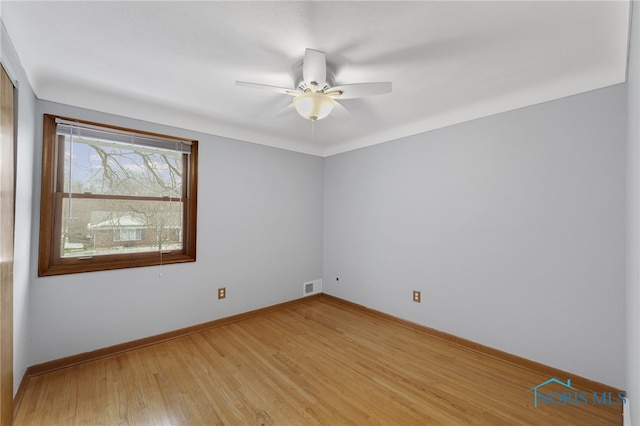 empty room featuring ceiling fan and light wood-type flooring