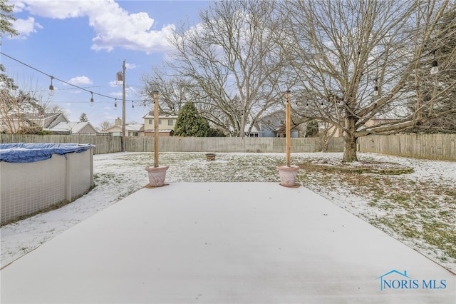 yard covered in snow featuring a covered pool