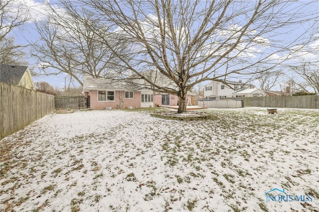 view of yard layered in snow