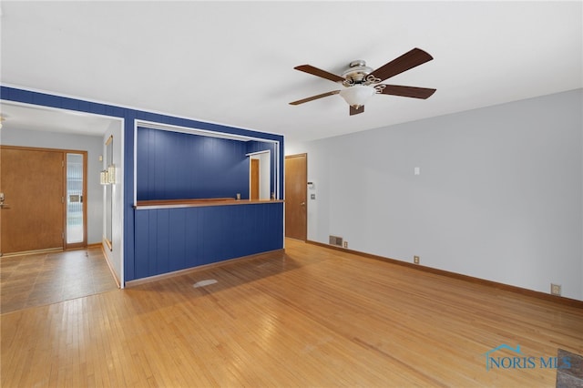 empty room featuring hardwood / wood-style flooring and ceiling fan