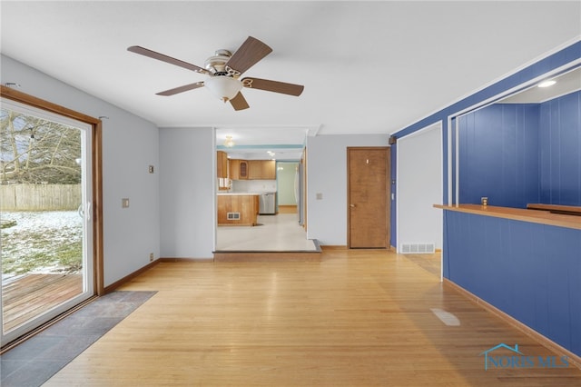 unfurnished living room featuring light wood-type flooring and ceiling fan