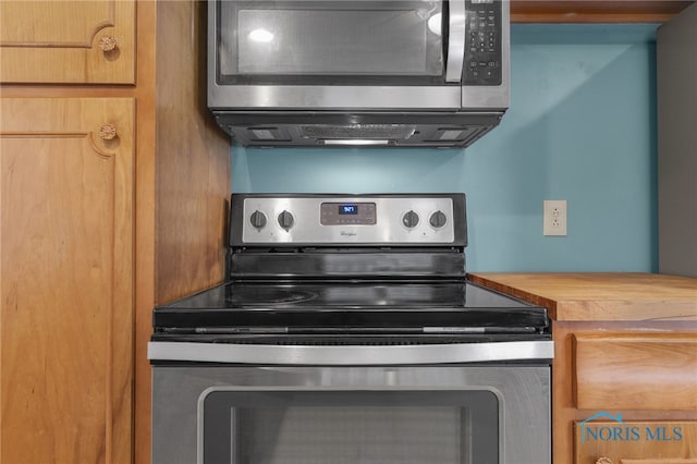 kitchen featuring wooden counters and appliances with stainless steel finishes