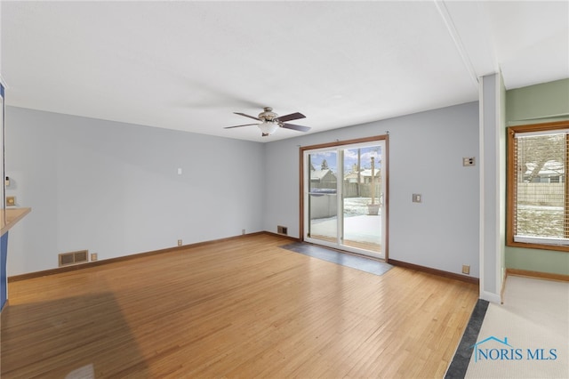 unfurnished living room featuring ceiling fan, light hardwood / wood-style floors, and a wealth of natural light