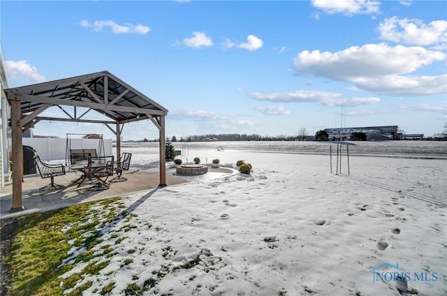 view of yard featuring a gazebo and an outdoor fire pit