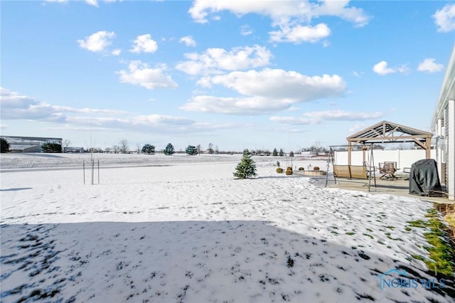 snowy yard with a gazebo