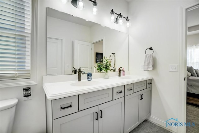 bathroom featuring tile patterned floors, vanity, and toilet