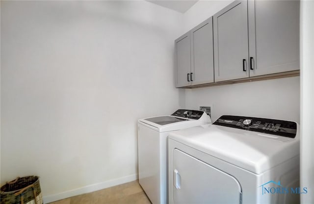 laundry area with cabinets and separate washer and dryer