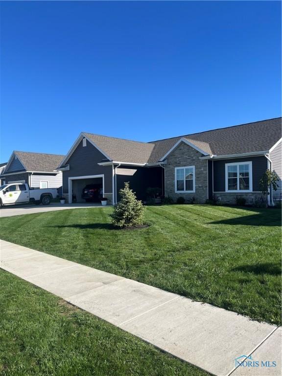 ranch-style home featuring a garage and a front yard