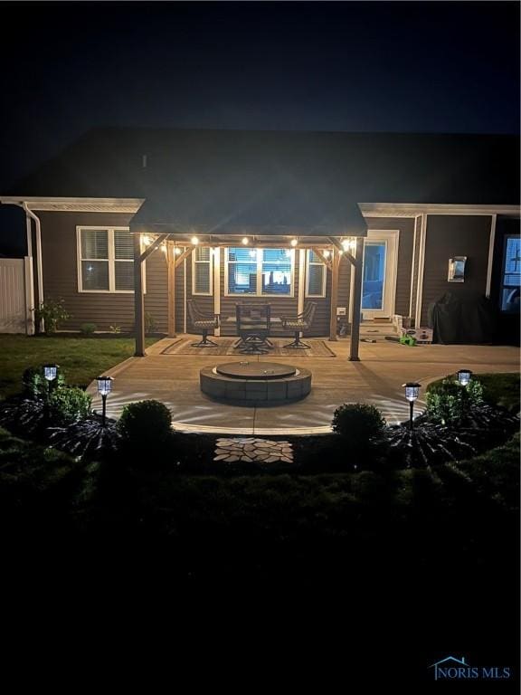 back house at twilight featuring a deck