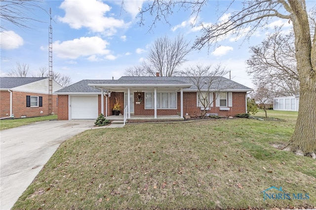 ranch-style home featuring a front yard, a garage, and covered porch