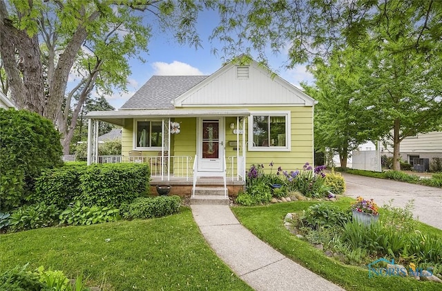 bungalow-style home featuring a porch and a front lawn