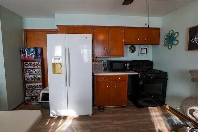 kitchen featuring ceiling fan, dark wood-type flooring, and black appliances