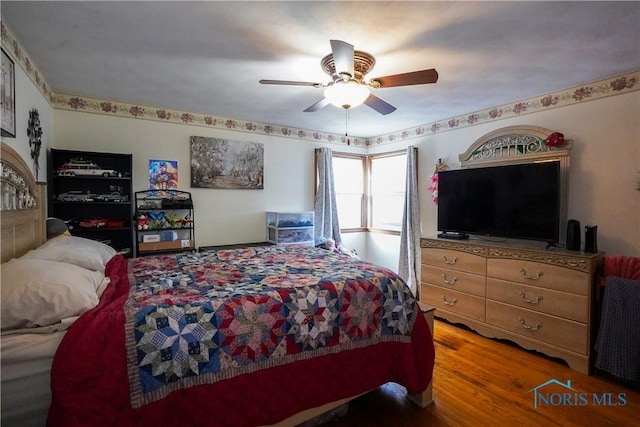 bedroom featuring wood-type flooring and ceiling fan