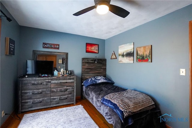 bedroom with hardwood / wood-style floors and ceiling fan