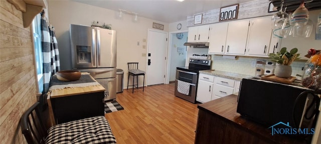 kitchen with white cabinetry, appliances with stainless steel finishes, light hardwood / wood-style floors, and tasteful backsplash