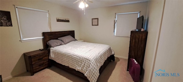 bedroom with ceiling fan and light carpet