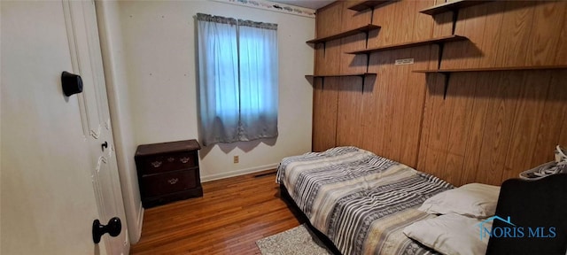 bedroom featuring dark hardwood / wood-style flooring