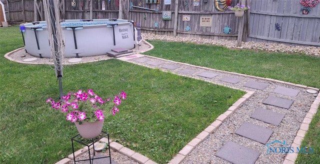 view of yard with a fenced in pool