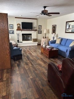 living room featuring ceiling fan, a textured ceiling, and dark wood-type flooring