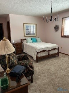 carpeted bedroom featuring a notable chandelier and a textured ceiling