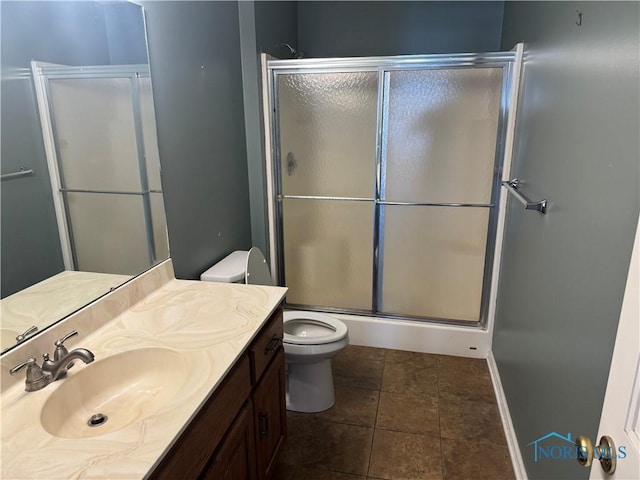 bathroom featuring vanity, toilet, tile patterned flooring, and a shower with door