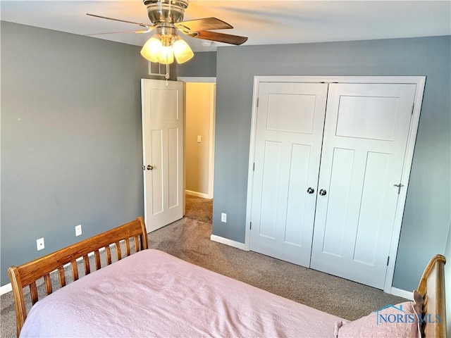 bedroom featuring ceiling fan, a closet, and carpet