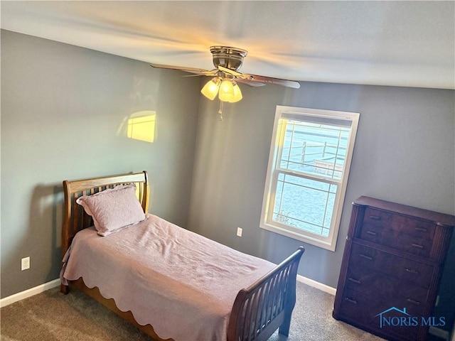 bedroom featuring ceiling fan and dark colored carpet