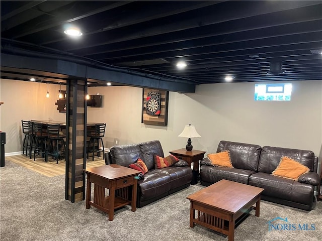 living room with carpet floors and bar