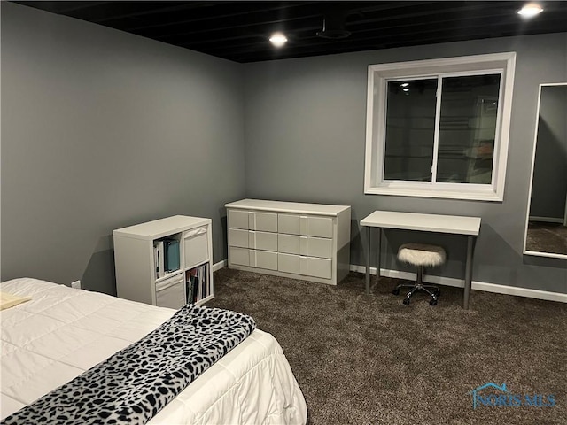 bedroom with dark colored carpet