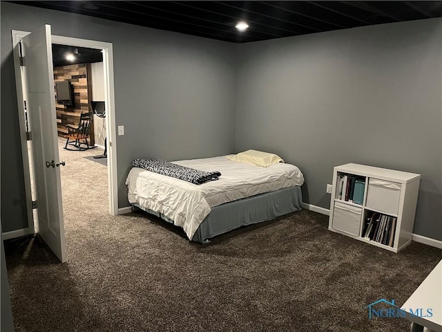 bedroom featuring dark carpet