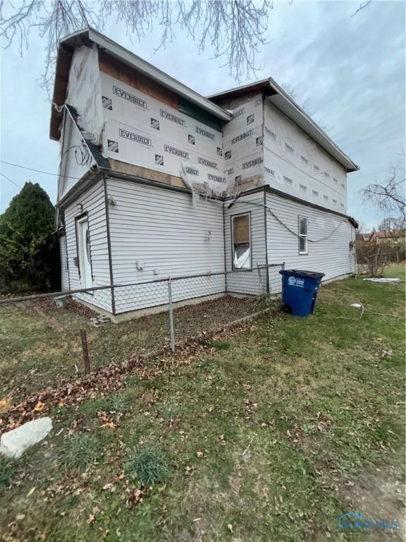 view of side of home with a lawn