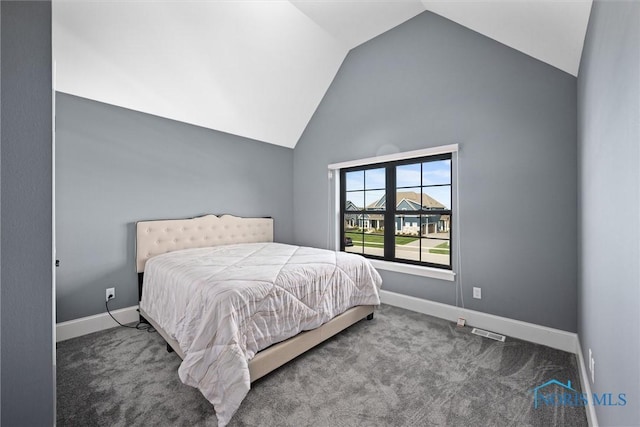 carpeted bedroom with vaulted ceiling