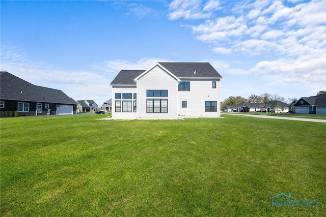 rear view of property with a lawn