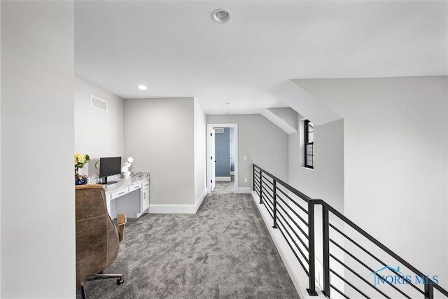 home office with light colored carpet and vaulted ceiling