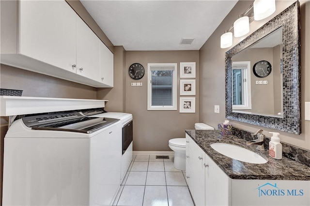 bathroom with vanity, tile patterned floors, washer and dryer, and toilet