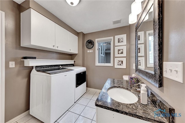 laundry room with sink, light tile patterned floors, and washing machine and clothes dryer