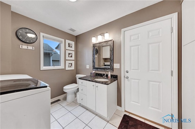 bathroom with vanity, tile patterned floors, and toilet